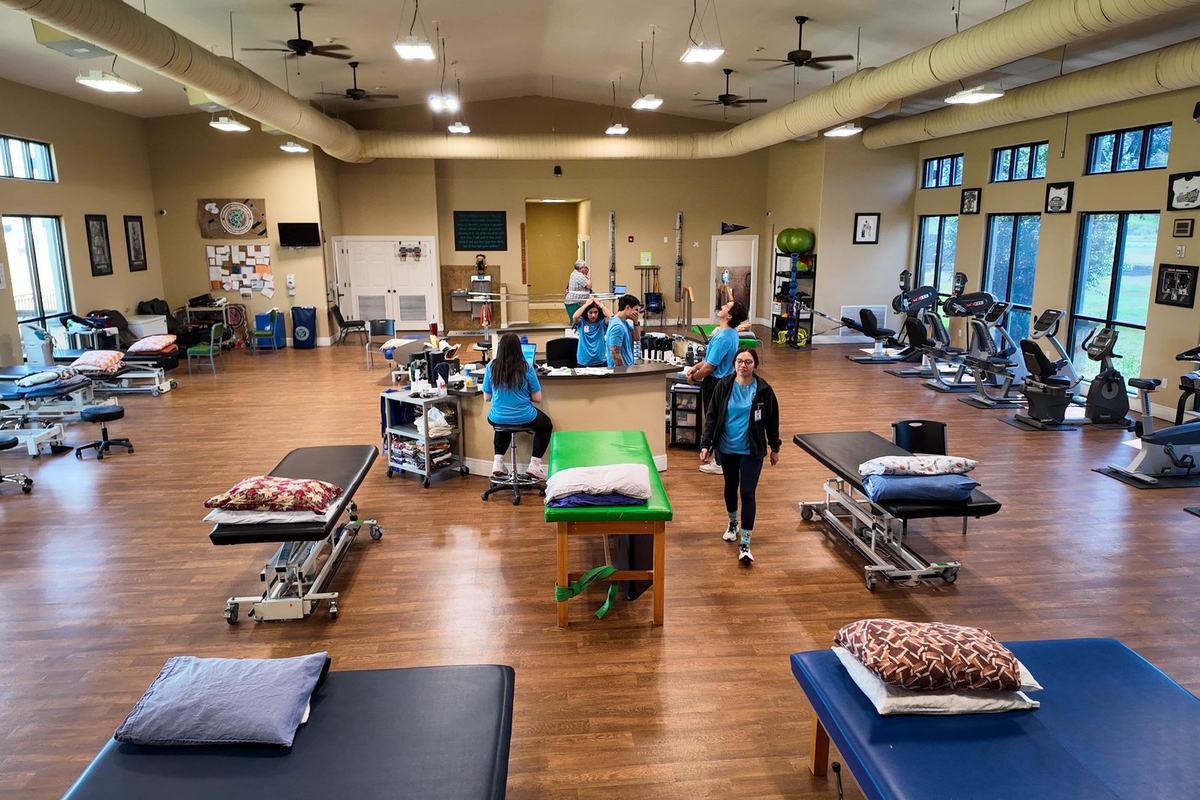 The rehab gym inside the Castroville rehabilitation center with treatment tables and open training floor